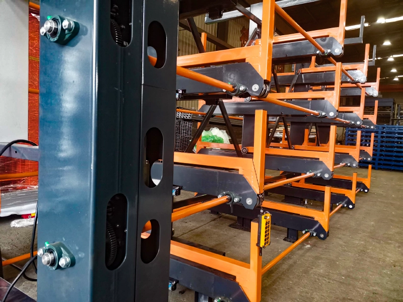 Terack Telescopic Cantilever Rack for Rainbow Aluminium 3 Industrial telescopic cantilever rack photo with orange steel frames, pivot arms, and roller-linked adjustable layers