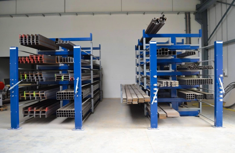 Roll Out Cantilever Rack Efficient 2 Real warehouse photo of a blue telescopic cantilever rack storing long steel tubes with hand-crank drive