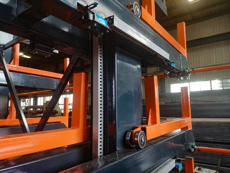 Touch with Roll Out Rack 4 Close-up of telescopic cantilever rack with roller-supported steel arms and perforated uprights for long materials storage