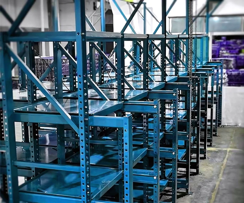 Rack Storage Mold Racking System Specification for Strattec 2 Blue three-post roll-out mold racks with fully extended drawers in an industrial workshop